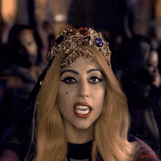 lady gaga is wearing a crown on her head and has a picture of her on the bottom right