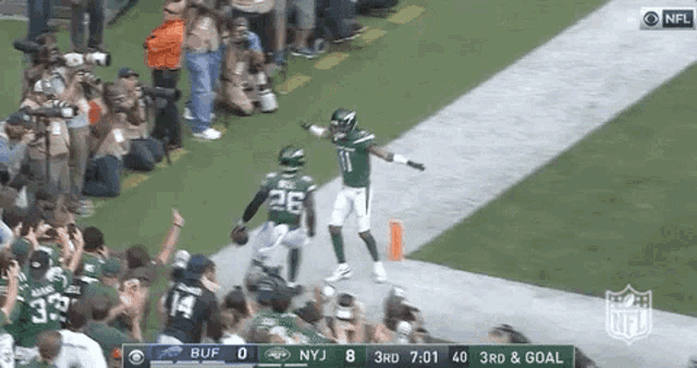 a new york jets football player celebrates a touchdown during a game .