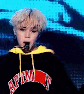 a person wearing a black hoodie with the word apm on it