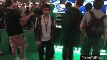 a group of people standing in front of a green screen with makeagif.com in the bottom right corner