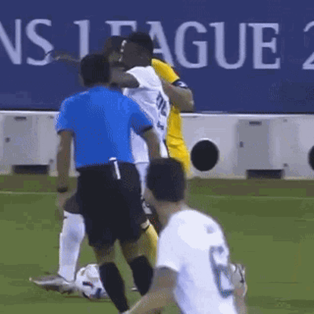 a soccer player with the number 6 on his jersey is being tackled by another player