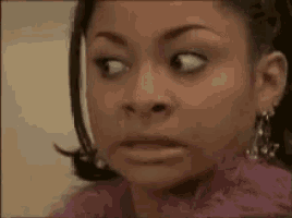 a close up of a woman 's face with a surprised expression .