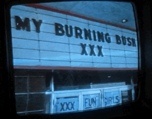 a tv screen shows a building with the words my burning bush xxx on it