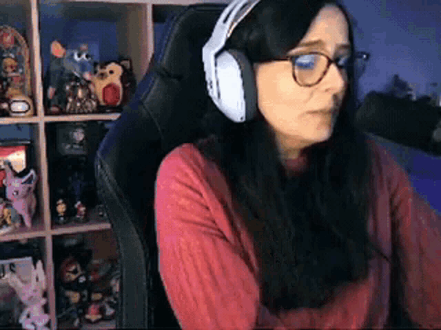 a woman wearing headphones is sitting in a chair .