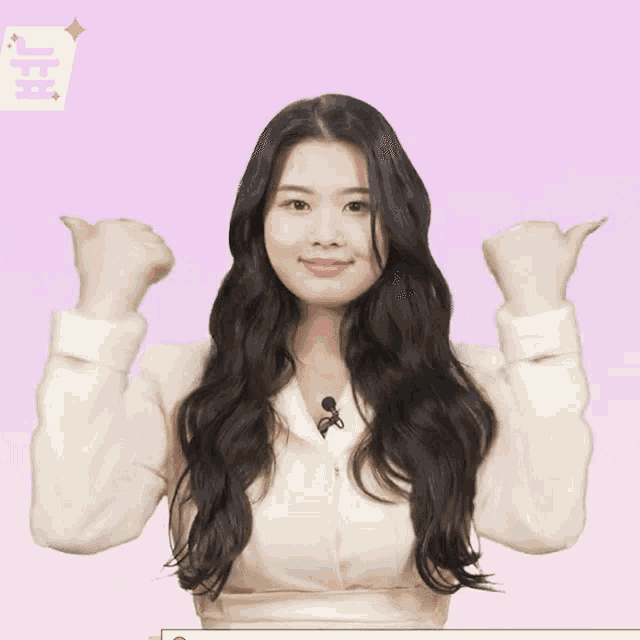 a girl with long black hair is giving a thumbs up
