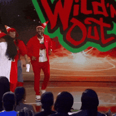 a group of people standing in front of a sign that says wild 'n ' out
