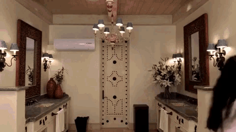 a bathroom with two sinks and two mirrors and a door that says ' emerson ' on it
