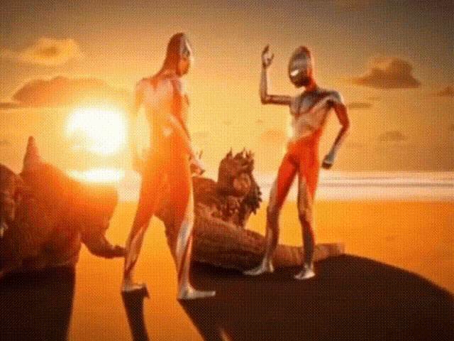 a couple of men standing on top of a rock with the sun behind them