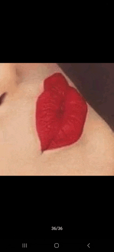 a close up of a person 's lips with red lipstick on their face .