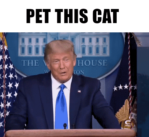 a man in a suit and tie stands at a podium and says pet this cat