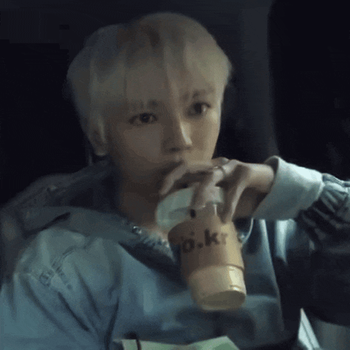 a man drinking from a cup that says yo.kr