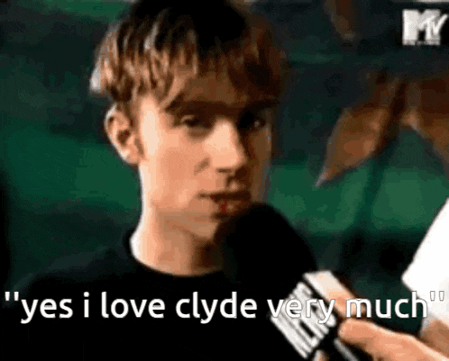 a man is talking into a microphone and says yes i love clyde very much .