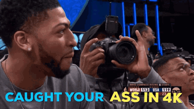 a man taking a picture with the words caught your ass in 4k