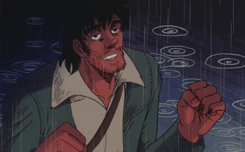 a man with a beard is standing in the rain with his fist up