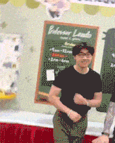 a man stands in front of a chalkboard that says professor lando