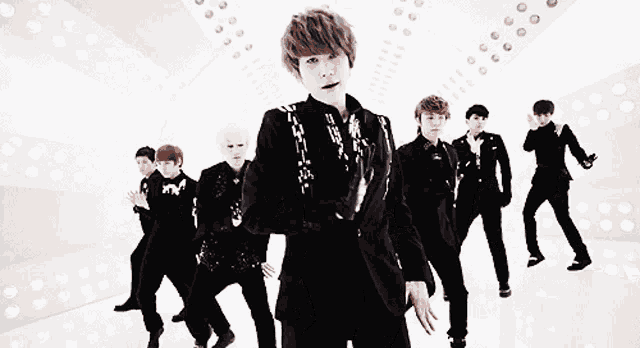 a group of young men are dancing in a room