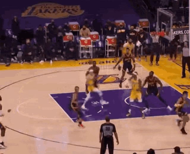 a basketball game is being played on a court with a lakers logo on it