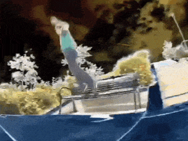 a person is doing a trick on a trampoline at night