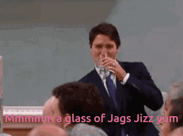 a man in a suit is drinking a glass of jags