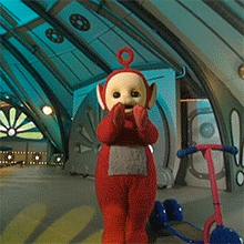 a group of teletubbies are walking in a building