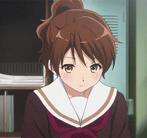 a girl with brown hair and yellow eyes is standing in front of a bookshelf