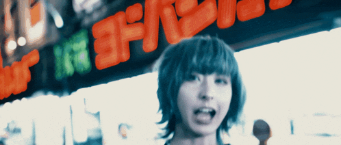 a woman stands in front of a neon sign that says ' spice ' on it