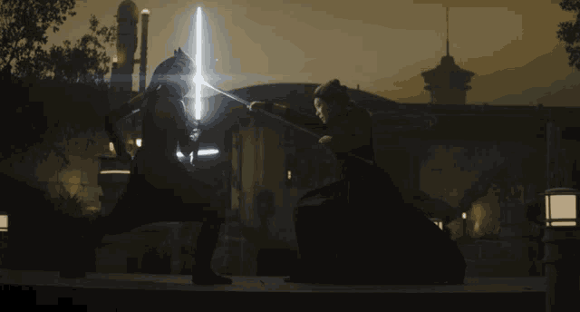 a man and a woman are fighting with lightsabers in front of a building