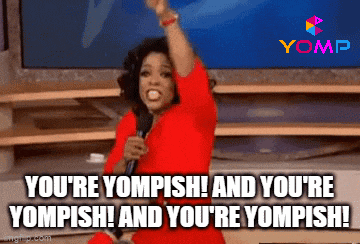 a woman in a red dress is holding a microphone and saying you 're yomish
