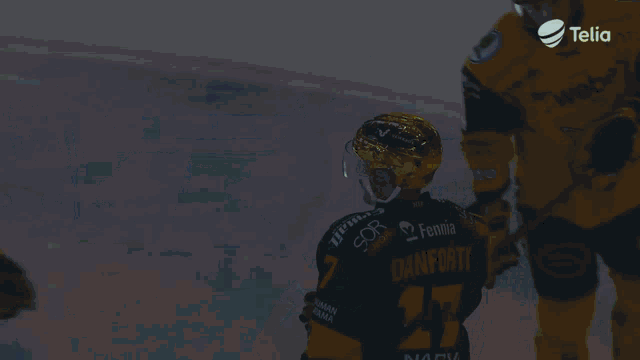 a hockey player in a yellow jersey with the number 62 on the back