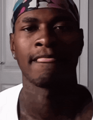 a close up of a man wearing a headband