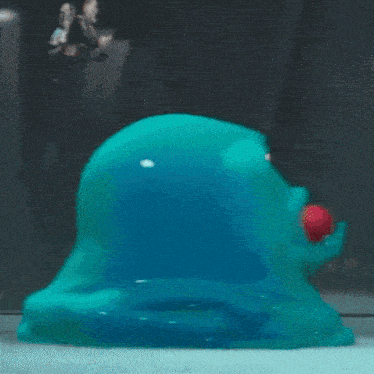 a cartoon character is looking at a blue blob with red eyes