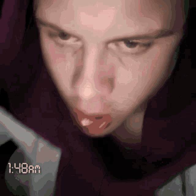 a close up of a person 's face with 1:48am written on the bottom