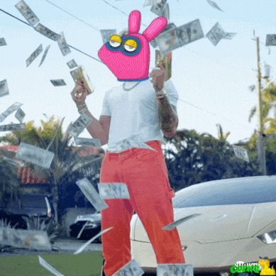 a man with a pink glove on his head is holding money