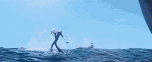 a man is riding a surfboard in the ocean .