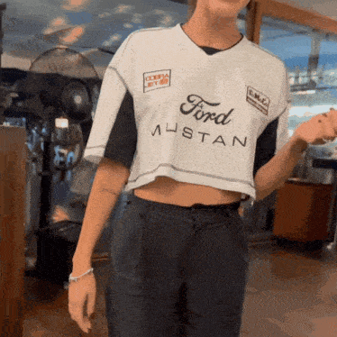 a woman is wearing a ford mustang shirt