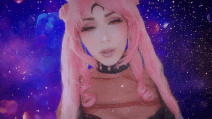 a woman with pink hair and a crescent moon on her head