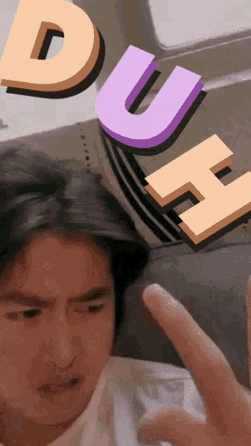 a man making a funny face with the word duh in the background