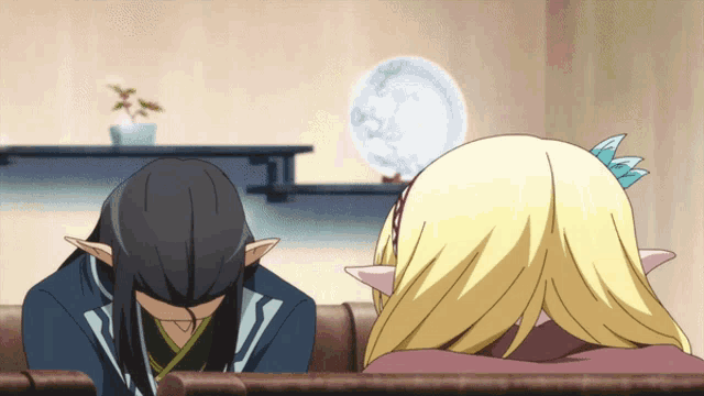 a man and a woman are sitting on a couch with their heads down