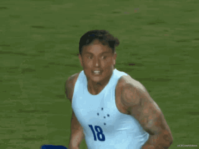 a soccer player wearing number 18 is running on the field
