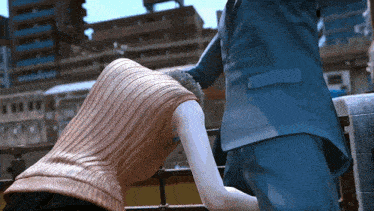 a man in a blue suit holds a woman 's hand