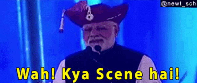 a man in a pirate hat speaking into a microphone with wah kya scene hai written on the bottom