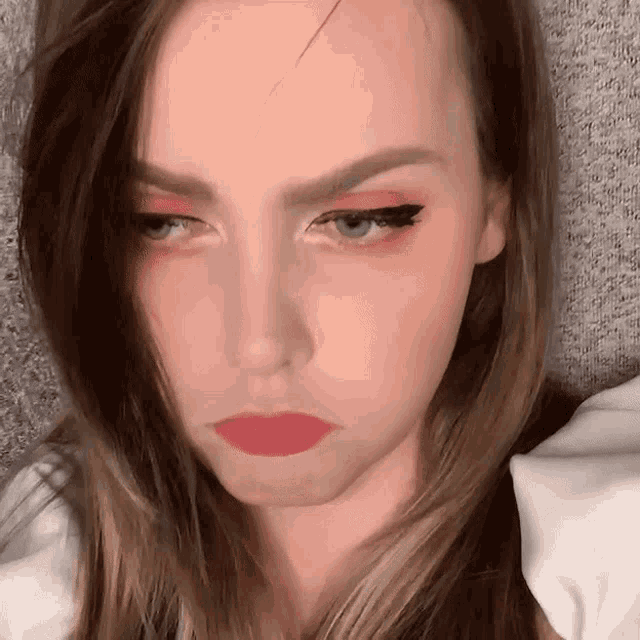 a close up of a woman 's face with red lips