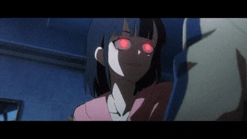 a girl with red eyes is sitting in a dark room with a person behind her .