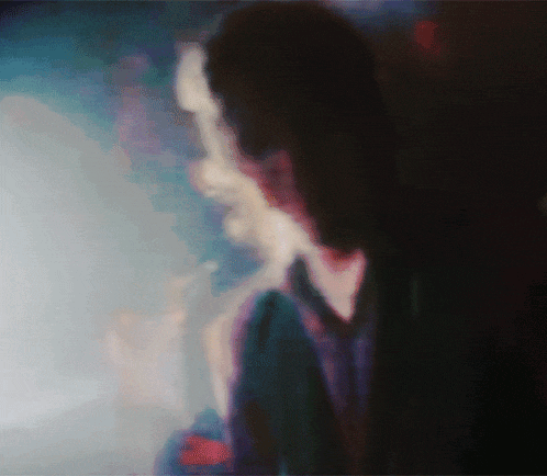 a blurry picture of a person 's face with a blue background