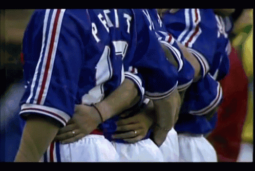 a group of soccer players are huddled together and one of them has the number 17 on his jersey