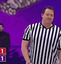 a man in a black and white striped shirt is standing on a stage .
