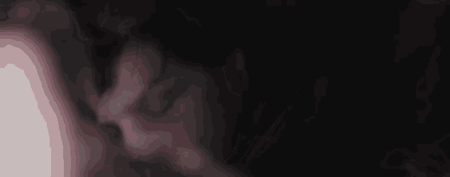 a close up of a person 's face with blood on it and smoke coming out of it .