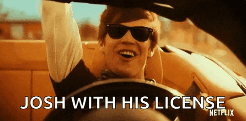a man wearing sunglasses is driving a car and the caption says josh with his license