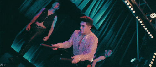 a group of people are dancing on a stage with a watermark that says " zkly "