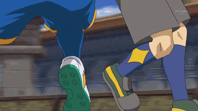 a soccer player is kicking a ball with a tv japan logo in the corner